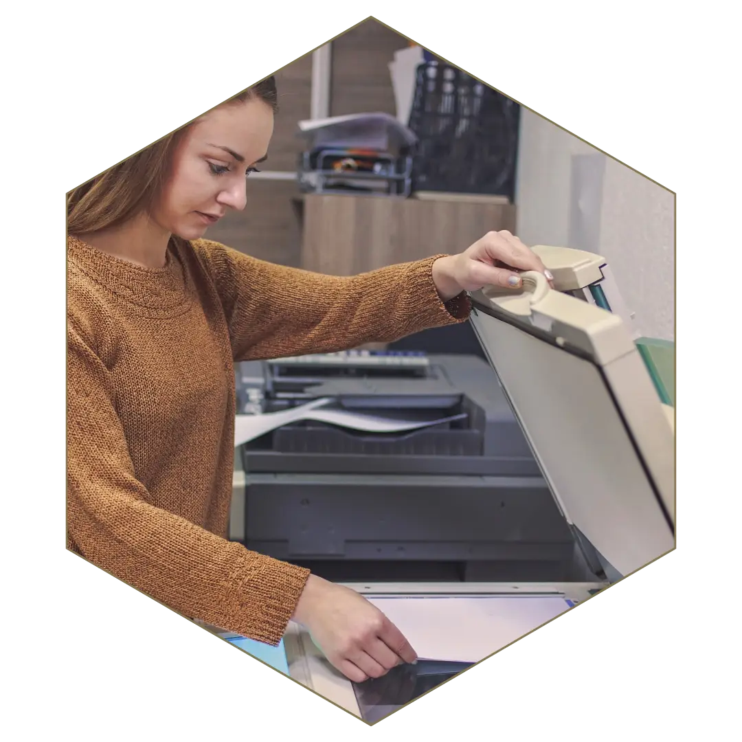 Employee using photocopier, symbolizing workplace investigations into HR issues, fraud, and misconduct.