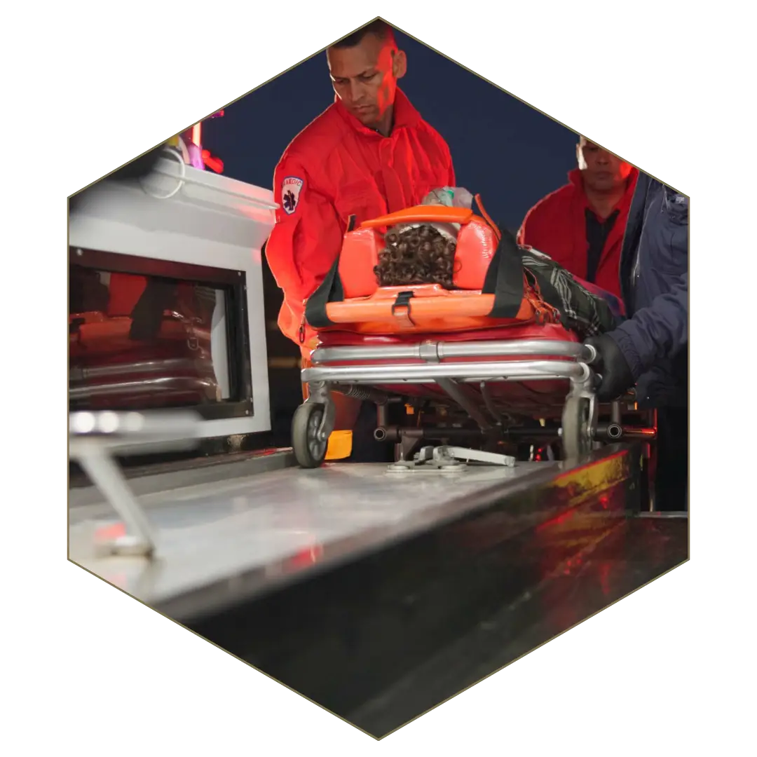 Paramedics moving patient into ambulance, symbolizing insurance investigations into claimant activities and medical cases.